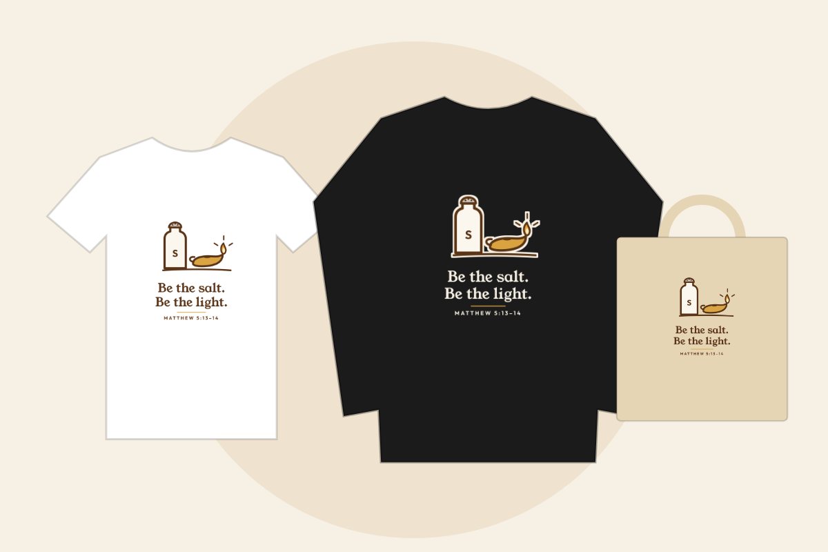 Hand-drawn salt shaker and oil lamp with the words Be the salt. Be the light., Matthew 5:13-14, on a white tee, black sweatshirt and natural tote bag